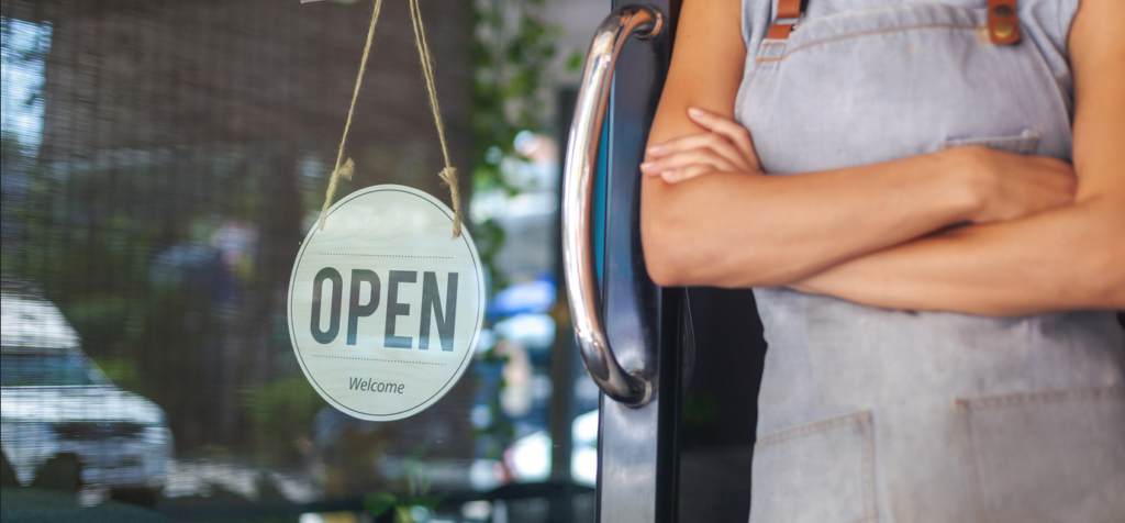 Woman next to an open sign